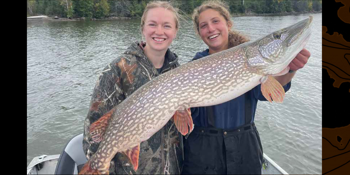 Girls posing with a Huge Pike